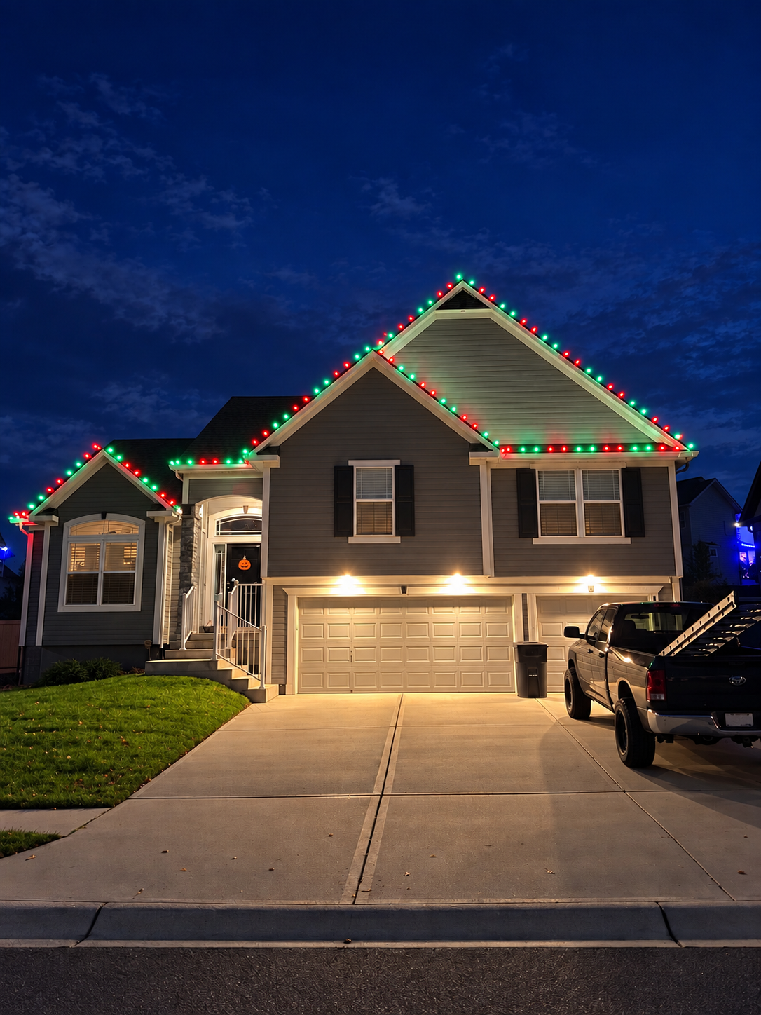 Split-level home with red, green, and white Christmas lights