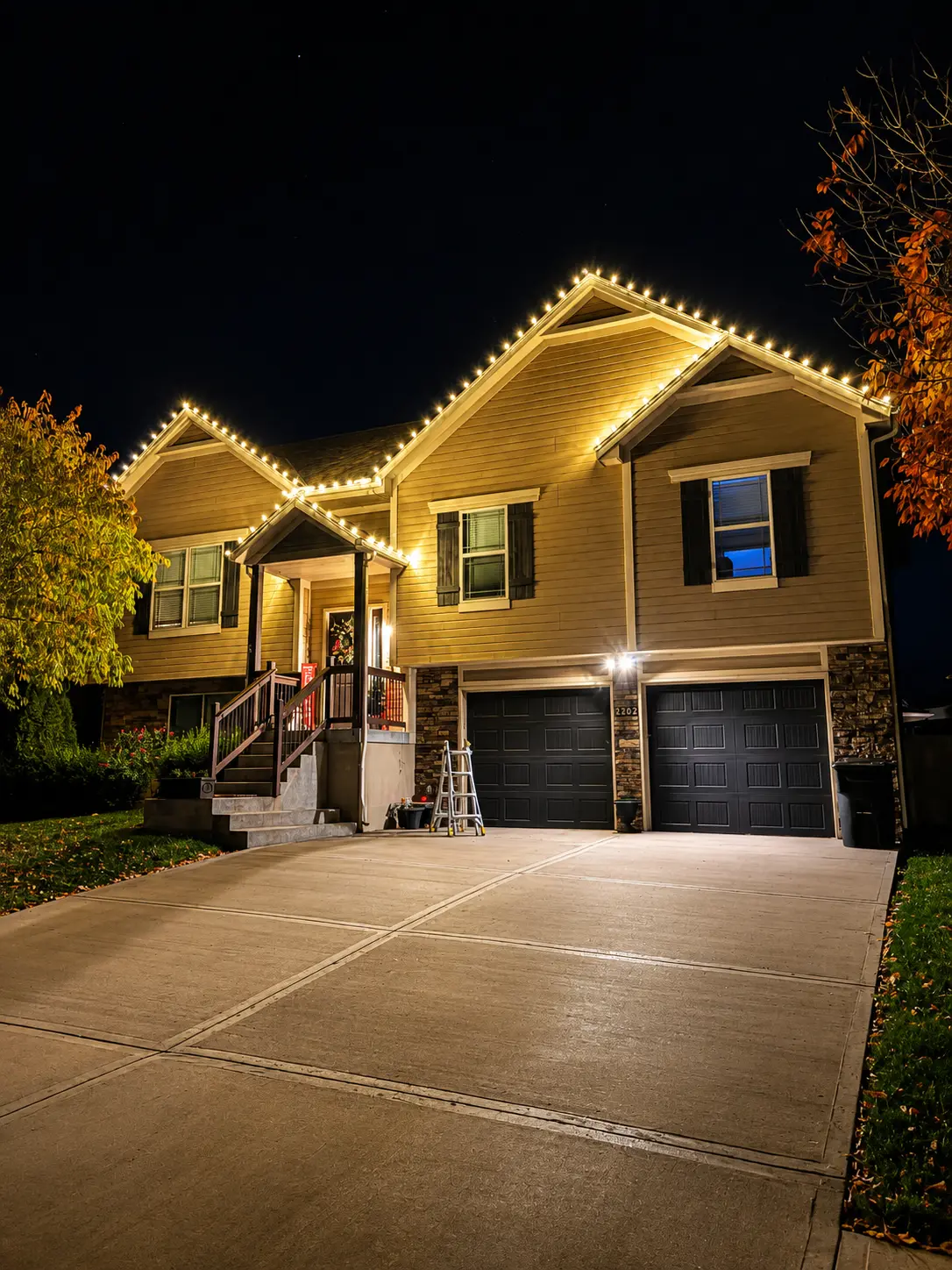 Home lined with warm white roofline lights during installation