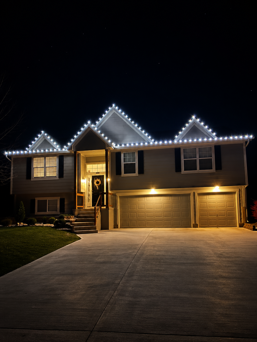 Two-story home with crisp cool white C9 lights along every roofline